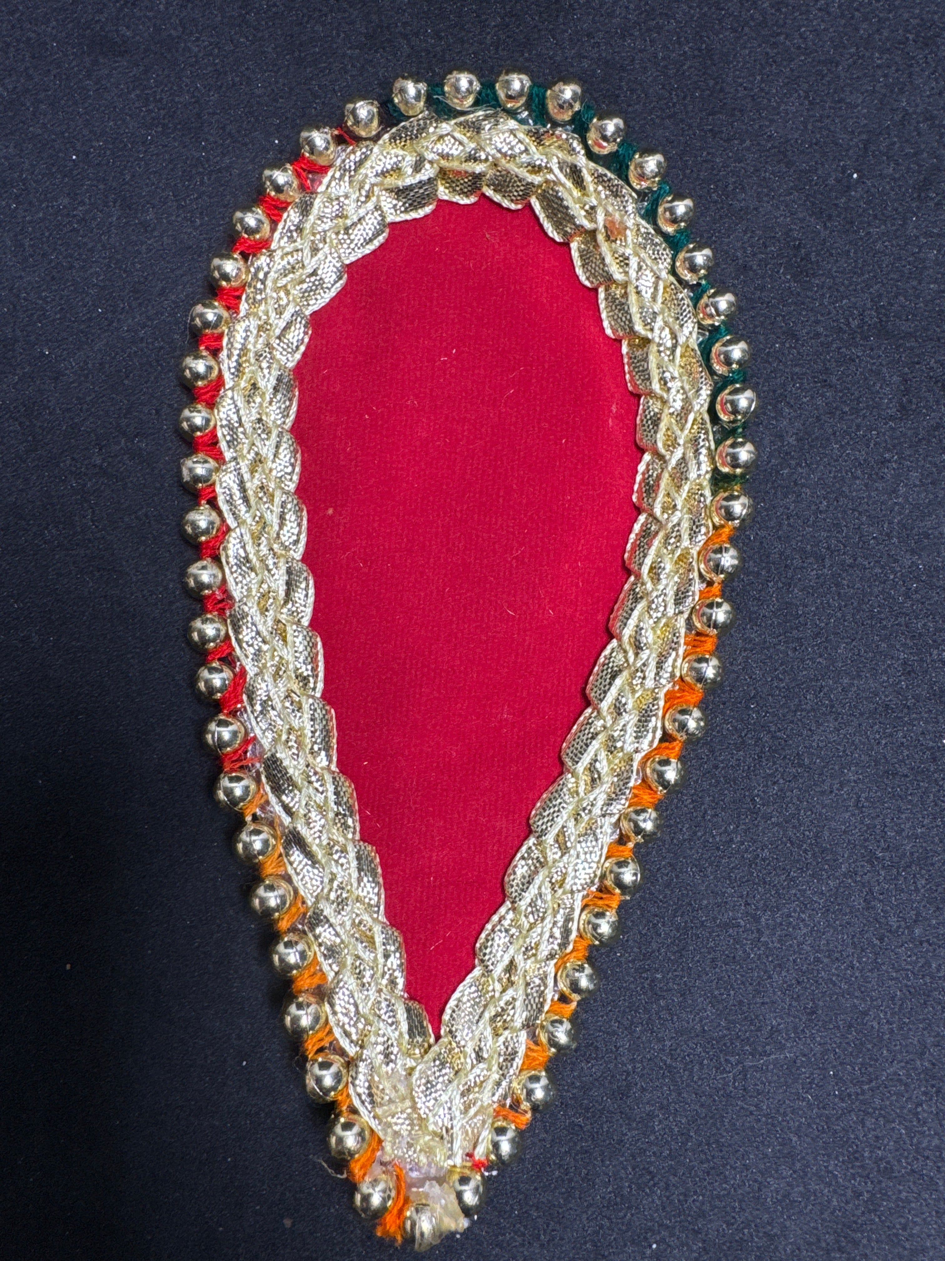 Mehndi Leaf with Gotta and Gems Elegant Design on Red Background Perfect for Traditional Mehndi Enthusiasts
