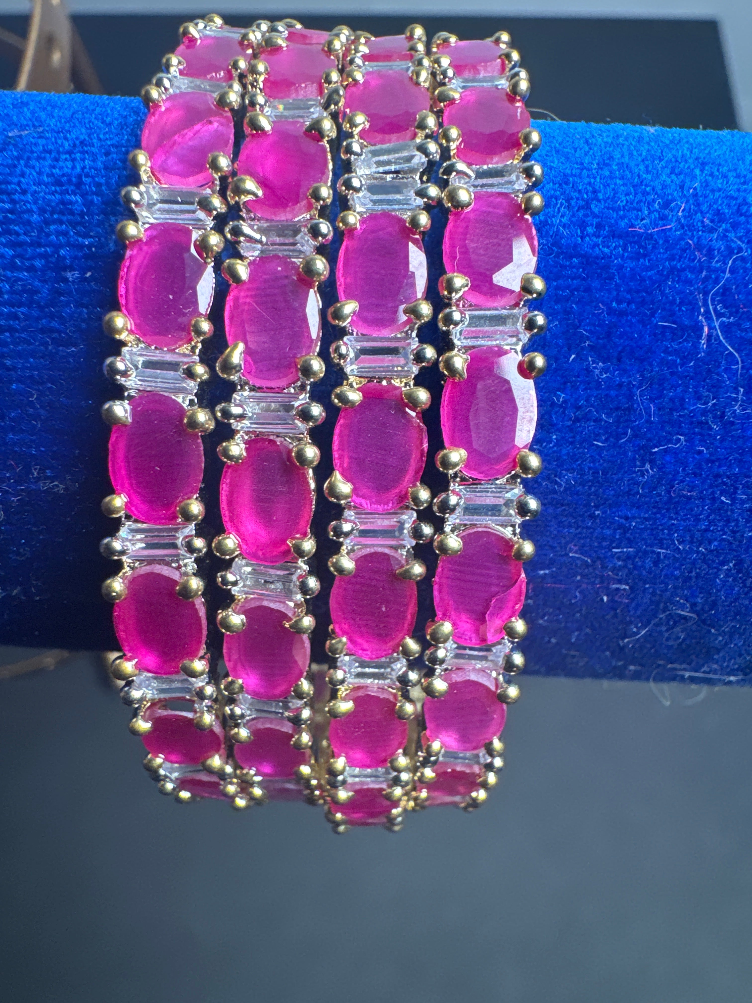 Gold colour set of 4 bangles with bright pink pearls