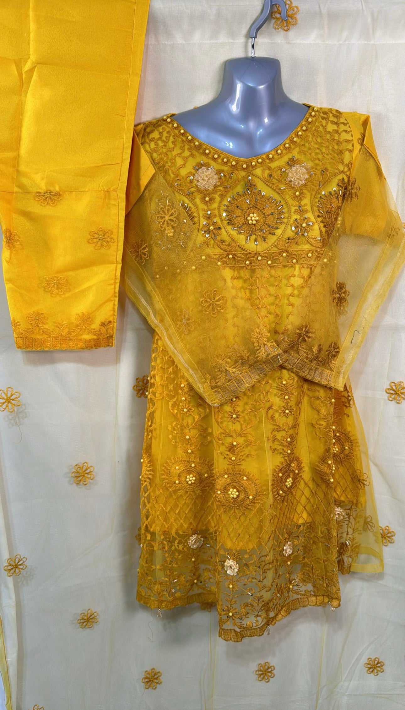 Yellow net frock with embroidery and bead work